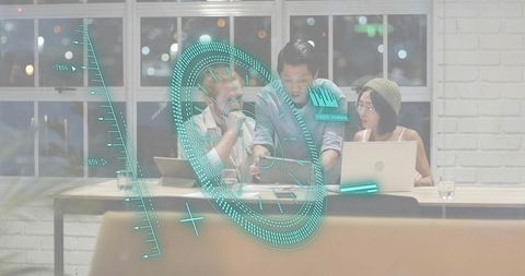 Team collaborating around laptops using augmented reality hud in night coworking workspace