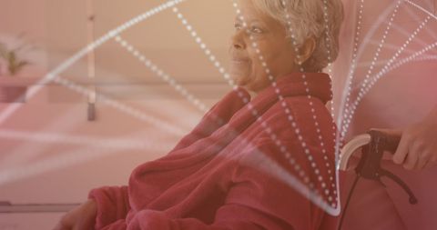 Senior woman patient in wheelchair with futuristic dna overlay
