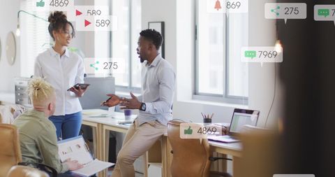 Colleagues engaged in social media strategy discussion at office