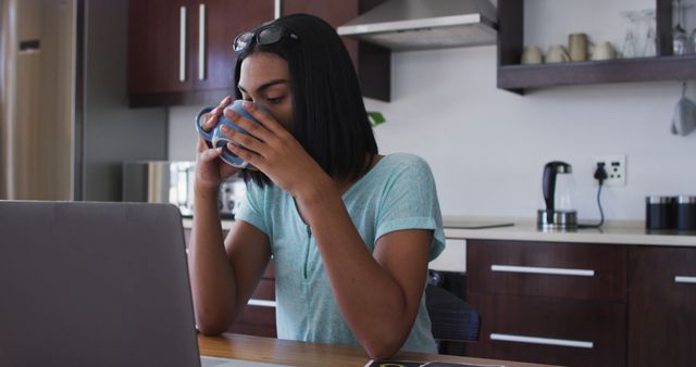 Young Woman Working from Home with Laptop in Kitchen, Drinking Coffee - Download Free Stock Images Pikwizard.com