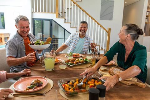 Friends Enjoying Cozy Meal Gathering with Fresh Cuisine in Elegant Home