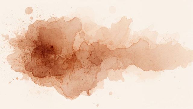 Sepia watercolor wash spreading across textured paper with pigment splatters and granulation