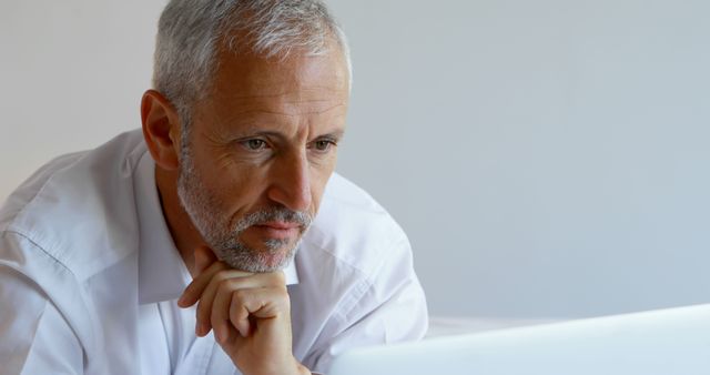 Focused Senior Man Using Laptop at Home Office - Download Free Stock Images Pikwizard.com