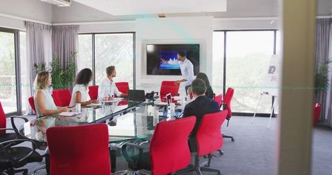 Diverse Team Analyzing Data Graph in Modern Meeting Room