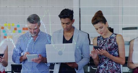 Multigenerational team using devices in modern office with digital charts and collaboration