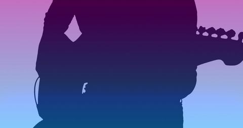 Silhouette of Guitarist Against Vibrant Gradient