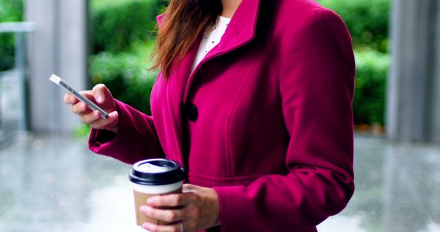 Woman in Magenta Coat Using Smartphone and Holding Coffee - Download Free Stock Images Pikwizard.com