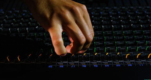 Hand Adjusting Soundboard Mixer in Dimly Lit Studio - Download Free Stock Images Pikwizard.com