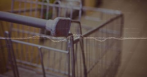 Weathered shopping cart handle showing chipped paint and rust with waveform overlay, grainy