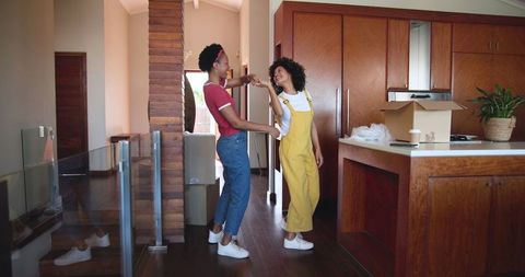 Couple Enjoying New Home Together While Unpacking