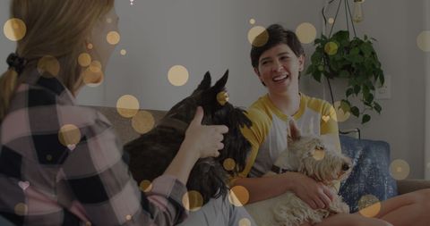 Joyful Female Couple Bonding with Pets at Home