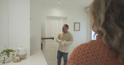 Couple Engaging in Domestic Chore in Modern Kitchen with Elegant Decor