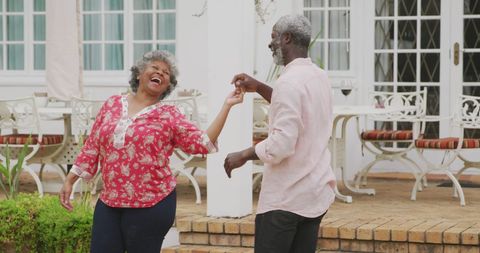 Joyful Senior Couple Dancing Together Outdoors
