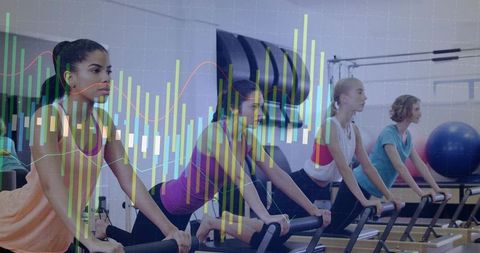 Women practicing reformer pilates in group class with digital fitness data overlay