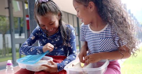 Two Girls Enjoying Lunch Break Sharing Moments of Friendship