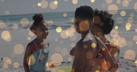 Family enjoying sunny beach day with laughing children, playful swim ring and golden bokeh