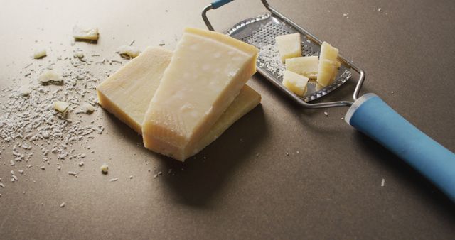 Blocks Of Parmesan Cheese With A Cheese Grater On A Brown Surface - Download Free Stock Images Pikwizard.com