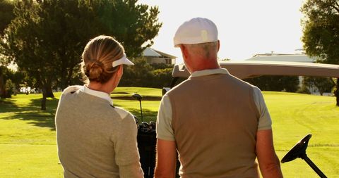 Senior Couple Enjoying Sunny Day on Golf Course - Download Free Stock Images Pikwizard.com