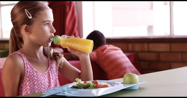 Young Girl Enjoying Healthy School Lunch with Juice - Download Free Stock Images Pikwizard.com