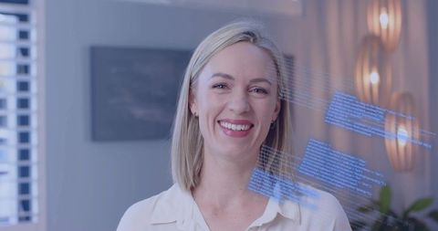 Smiling Professional Standing Amidst Digital Code Overlays in Modern Office