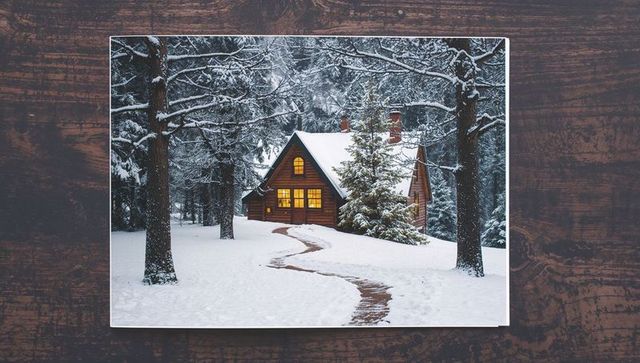 Cozy Snow-Covered Cabin with Warm Glowing Windows in Twilight Forest, Winding Snowy Path