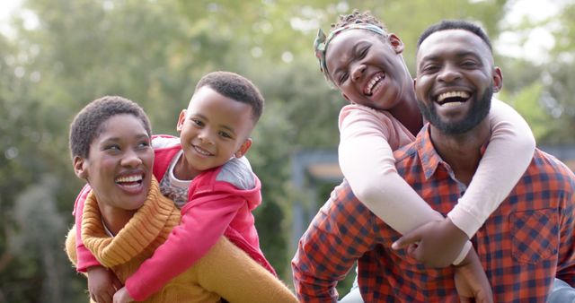 Happy African American Family Piggyback Outdoors in Park - Download Free Stock Images Pikwizard.com