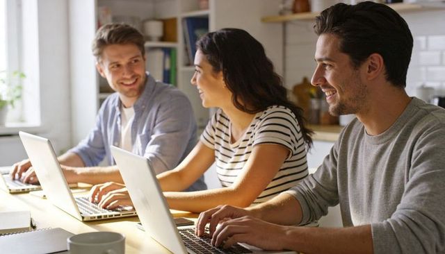 Young professionals collaborating at bright kitchen workspace, remote teamwork and study