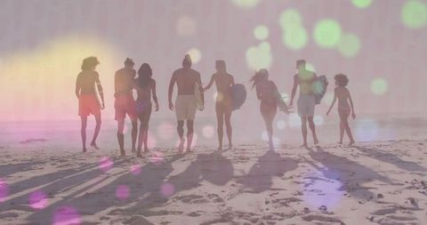 Friends Walking to Sunset Surf with Boards on Colorful Shoreline