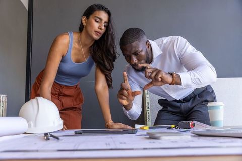 Diverse Coworkers Collaborating on Architectural Project Planning