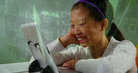 Smiling girl using tablet for online learning with green stock market data and growth arrow