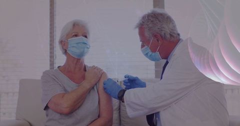 Doctor Administering Vaccine to Elderly Woman in Medical Office