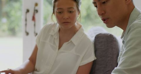 Couple planning wedding together with laptop