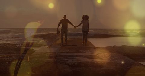 Romantic African American Couple Walking on Sea Rocks at Sunset - Download Free Stock Images Pikwizard.com
