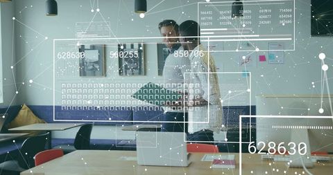 Two professionals discussing data with holographic analytics overlay in modern office