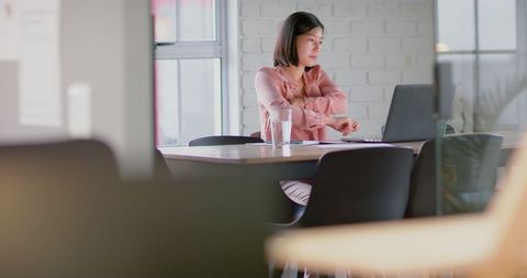 Asian Businesswoman Working on Laptop in Modern Office