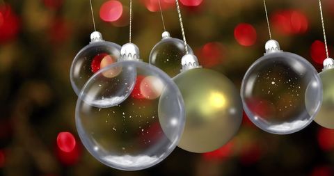 Dangling Christmas Baubles with Festive Lights Background - Download Free Stock Images Pikwizard.com