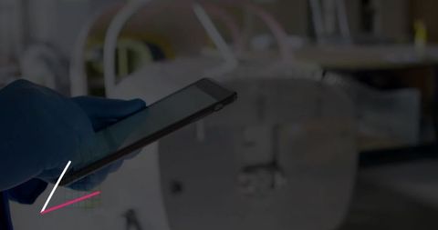 Gloved healthcare professional using tablet in radiology environment