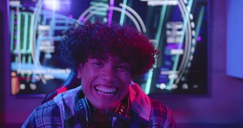 joyful gamer enthusiast in cozy home setup with headset - Download Free Stock Images Pikwizard.com