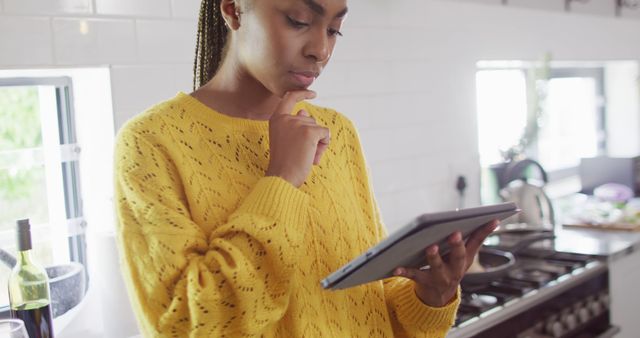 Young Woman with Tablet in Modern Kitchen, Contemplating Recipe - Download Free Stock Images Pikwizard.com