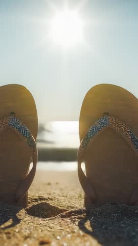 Sunrise Lighting Flip-Flops on Sandy Shore with Gliding Seagull | Vertical Beach Video