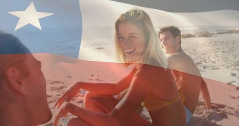 Smiling friends enjoying beach vacation with patriotic flag overlay, summer travel