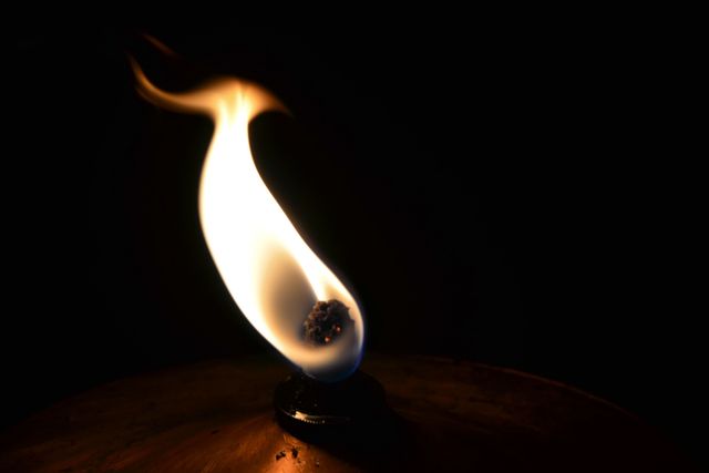 Close-Up of Single Flame in Dark Setting - Download Free Stock Photos Pikwizard.com