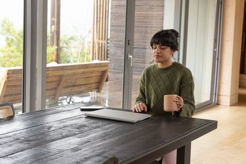 Relaxed Woman Enjoying Coffee Break at Modern Home Office