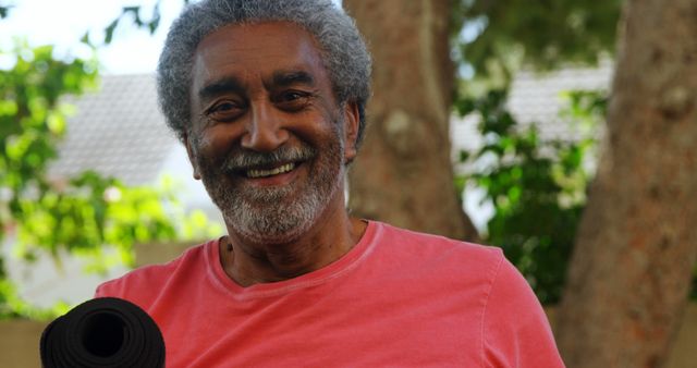 Senior Man Smiling While Holding a Yoga Mat Outdoors - Download Free Stock Images Pikwizard.com