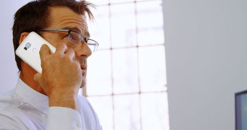 executive in office engaged in phone conversation - Download Free Stock Images Pikwizard.com