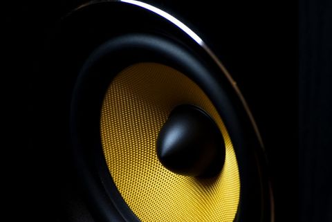 Yellow woofer cone delivering powerful bass for studio monitor and hifi audio equipment