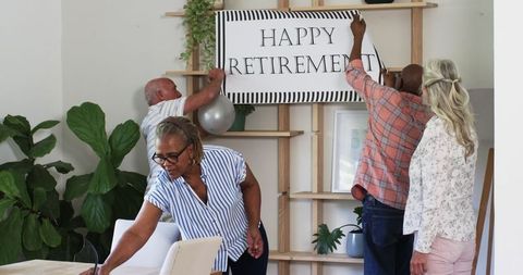 Senior friends decorating for retirement celebration at home