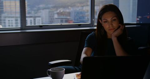 Young Professional Woman Using Laptop Contemplates Work in Modern Office - Download Free Stock Images Pikwizard.com