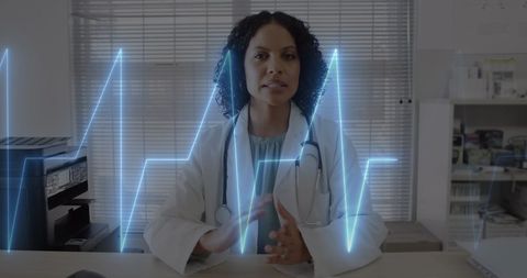 Confident Female Doctor Engaging in Virtual Consultation with Cardio Imagery - Download Free Stock Images Pikwizard.com