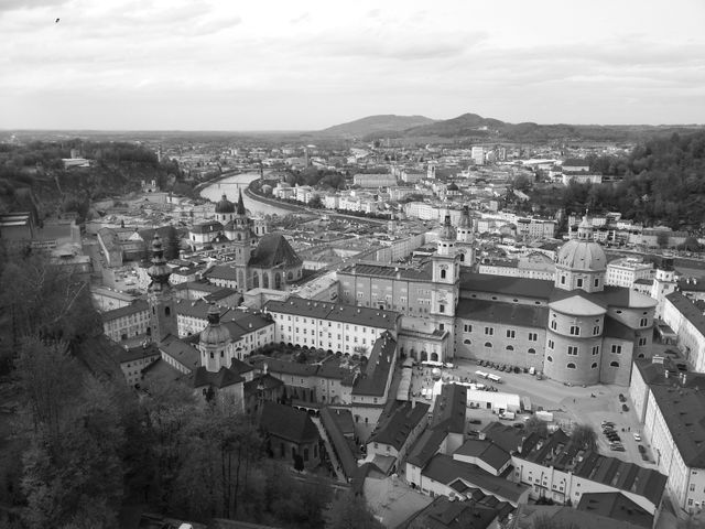 Black and white aerial view showing historic European cityscape with river running through, and numerous dome buildings. Suitable for projects related to tourism, history, architecture, urban studies, or artistic photography displays emphasizing classic architectural beauty.